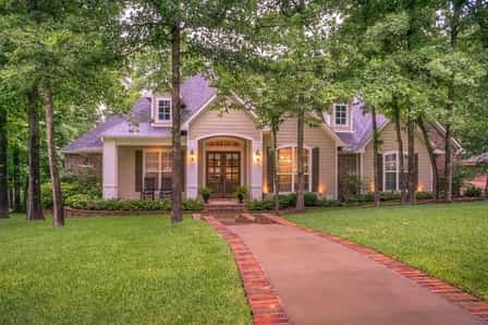 Beautiful front yard with brick edged sidewalk up to front door